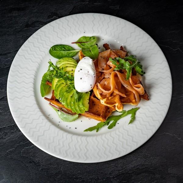 Waffles with salmon, avocado and poached egg